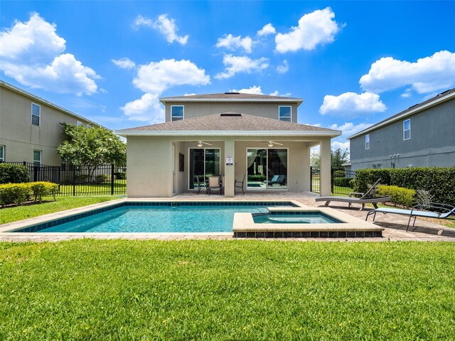 311 W Falls Dr, Kissimmee, FL 34747 - rear view of property featuring ceiling fan, stucco siding, a shingled roof, a patio, and a pool with connected hot tub
