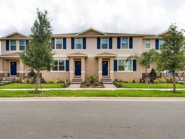 1566 Dalehurst Ln, Kissimmee, FL 34744 - view of property with stucco siding, a front lawn, and entry steps