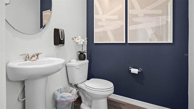 1566 Dalehurst Ln, Kissimmee, FL 34744 - bathroom featuring toilet, baseboards, wood finished floors, and a sink