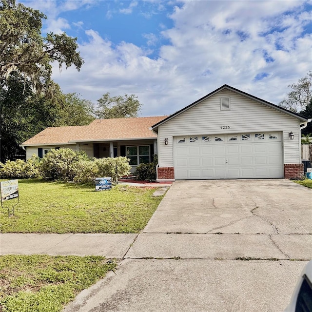 4235 Shades Crest Ln, Sanford, FL 32773 - ranch-style home featuring brick siding, a garage, concrete driveway, and a front yard