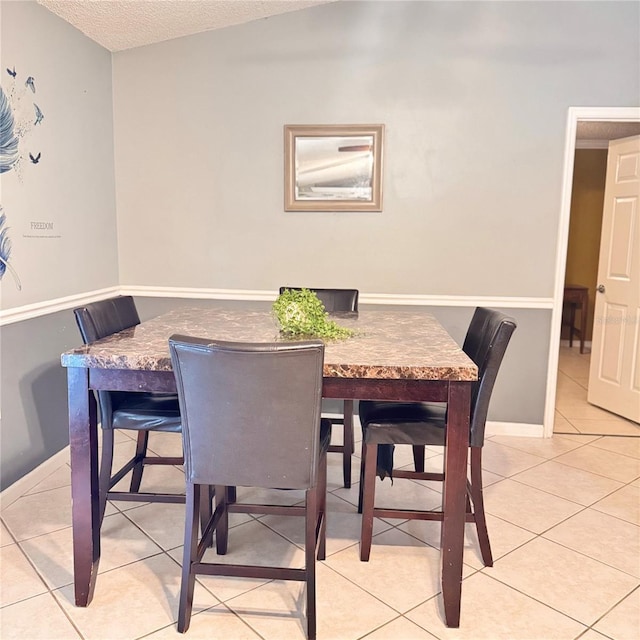 4235 Shades Crest Ln, Sanford, FL 32773 - dining room with a textured ceiling, light tile patterned flooring, and baseboards