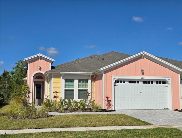 726 Coral Reef Way, Daytona Beach, FL 32124 - view of front of house featuring board and batten siding, a garage, decorative driveway, and a shingled roof