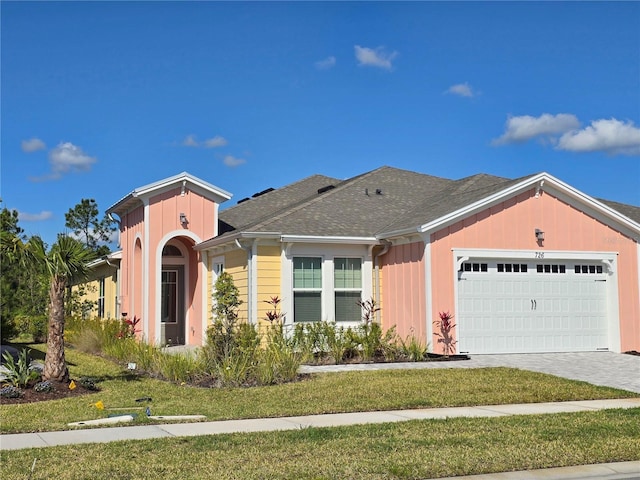 726 Coral Reef Way, Daytona Beach, FL 32124 - view of front facade featuring an attached garage, board and batten siding, driveway, and a front yard