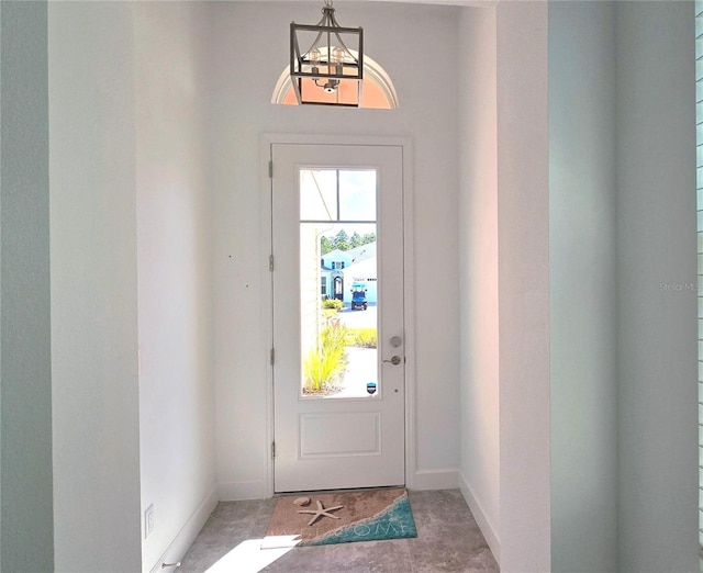 726 Coral Reef Way, Daytona Beach, FL 32124 - entryway featuring baseboards and a chandelier