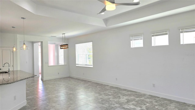 726 Coral Reef Way, Daytona Beach, FL 32124 - unfurnished living room featuring healthy amount of natural light, a sink, and baseboards
