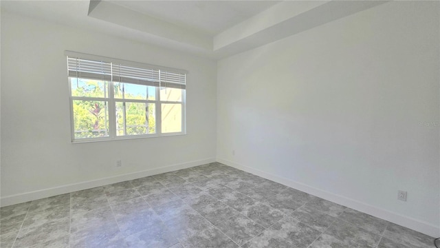 726 Coral Reef Way, Daytona Beach, FL 32124 - unfurnished room with baseboards and a tray ceiling