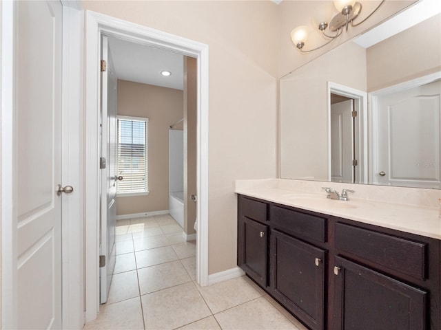 bathroom featuring vanity, tile patterned flooring, baseboards, and bathtub / shower combination