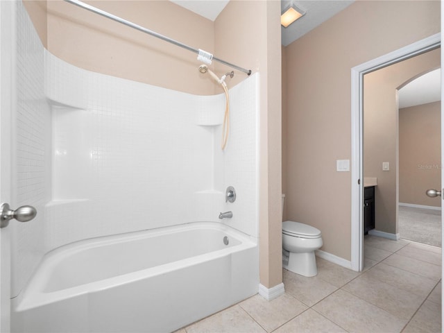 full bath with toilet, tile patterned flooring, vanity, bathtub / shower combination, and baseboards