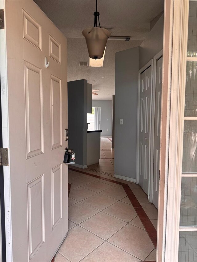 1603 Emily Ct, Kissimmee, FL 34744 - hall featuring light tile patterned floors and baseboards