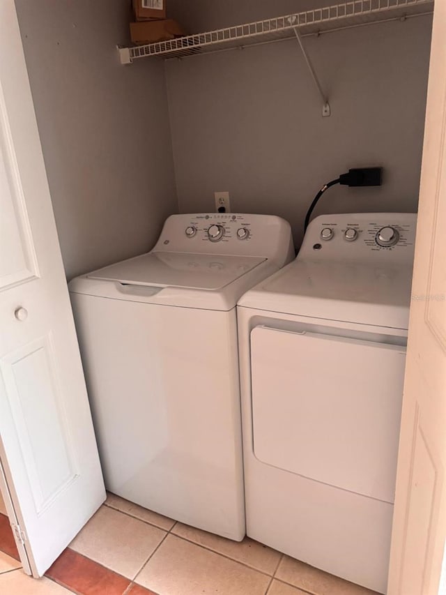 1603 Emily Ct, Kissimmee, FL 34744 - laundry room with washer and dryer and light tile patterned flooring