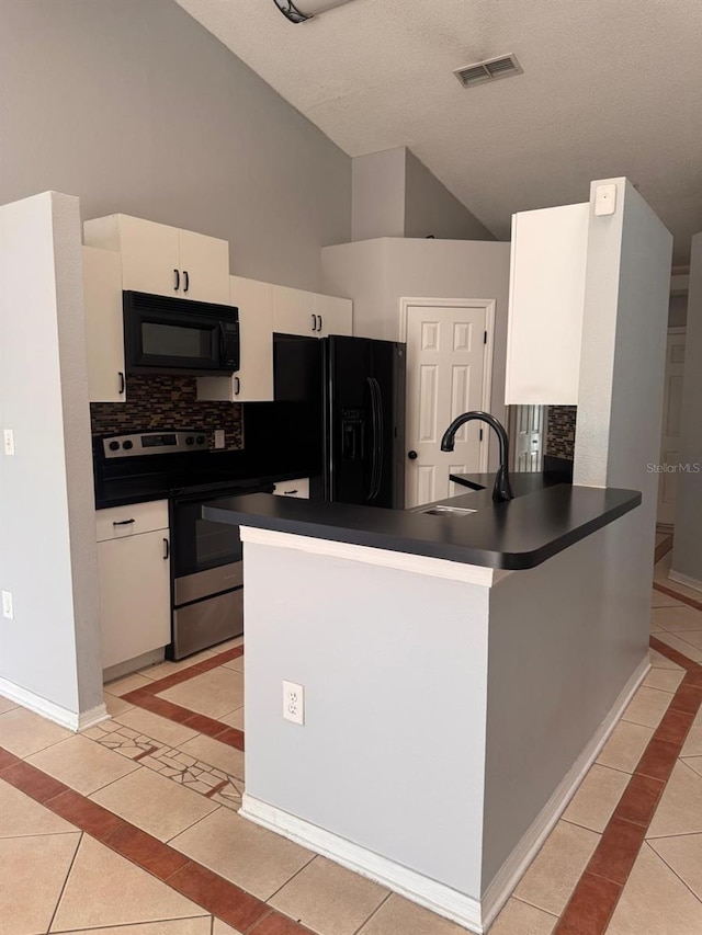 1603 Emily Ct, Kissimmee, FL 34744 - kitchen with black appliances, dark countertops, light tile patterned floors, inlaid floor details, and decorative backsplash