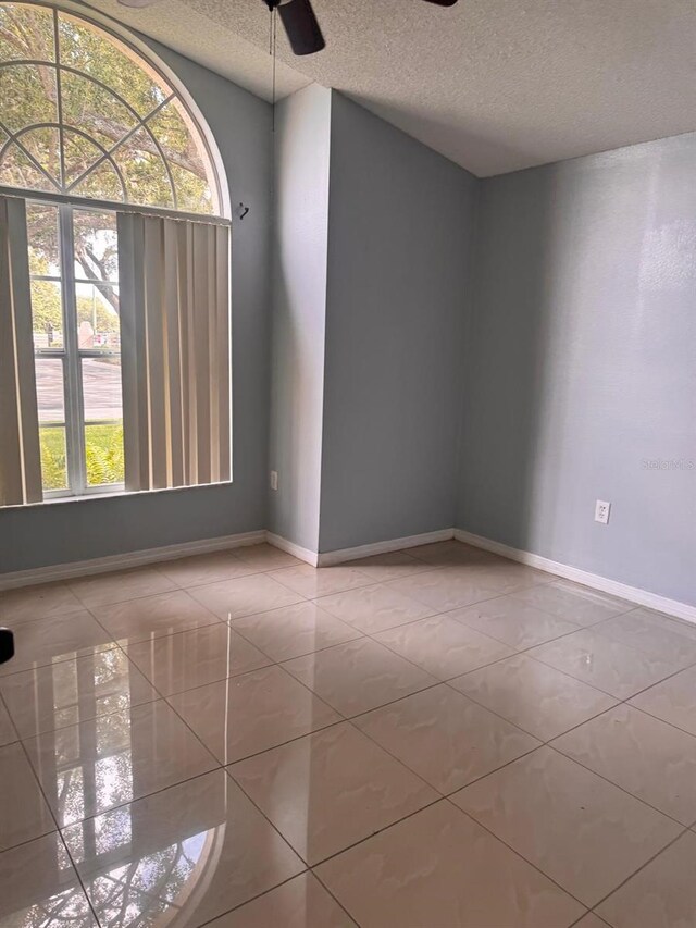 1603 Emily Ct, Kissimmee, FL 34744 - tiled spare room with a textured ceiling and a ceiling fan