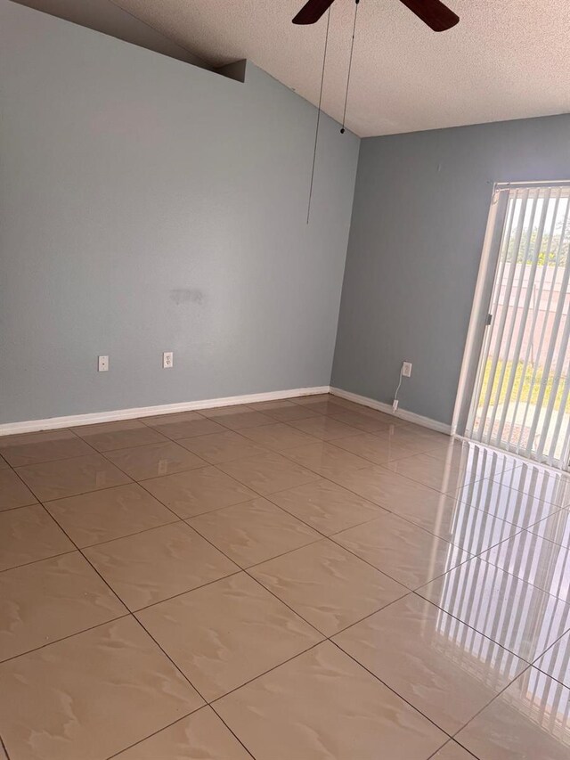 1603 Emily Ct, Kissimmee, FL 34744 - tiled empty room featuring a ceiling fan and a textured ceiling