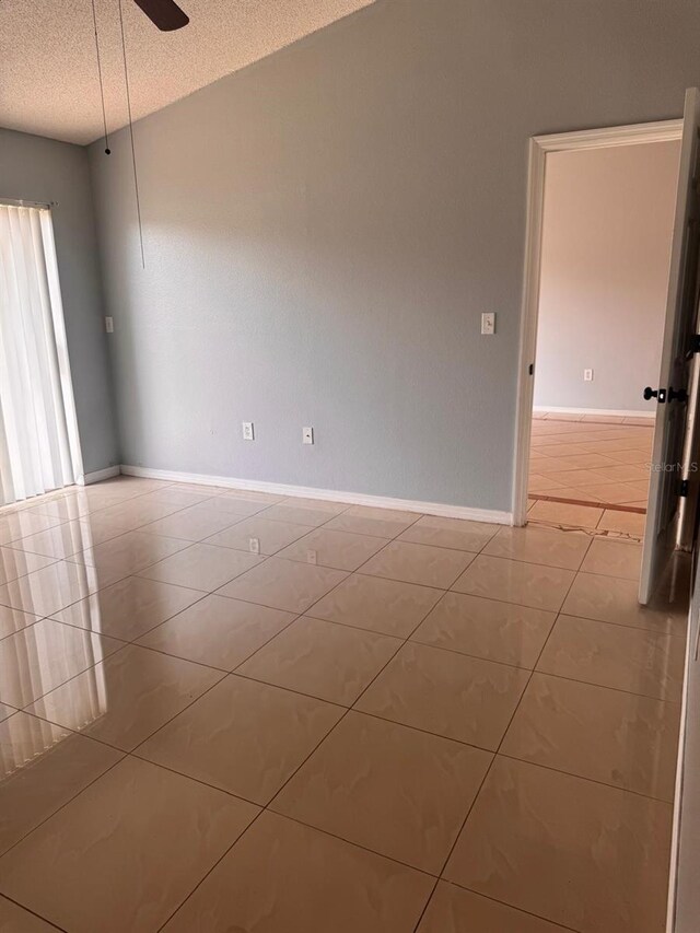 1603 Emily Ct, Kissimmee, FL 34744 - unfurnished room featuring light tile patterned flooring, a textured ceiling, and ceiling fan