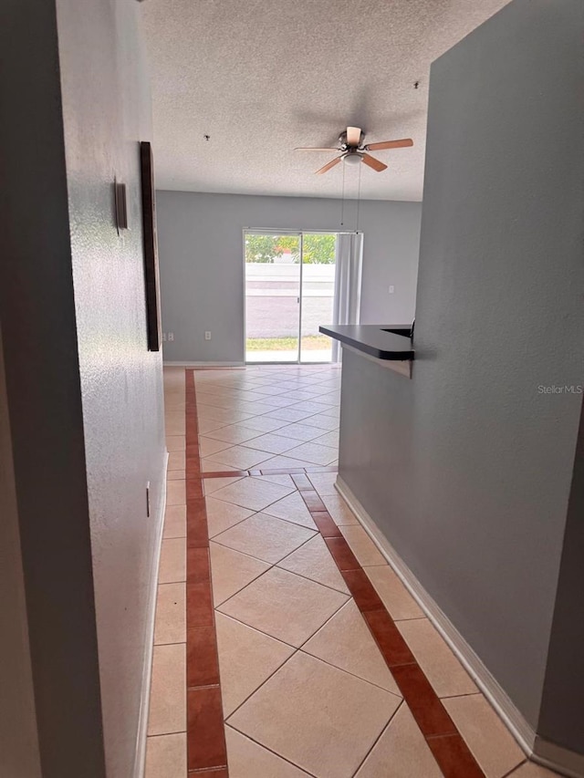 1603 Emily Ct, Kissimmee, FL 34744 - corridor with light tile patterned flooring, inlaid floor details, and a textured ceiling