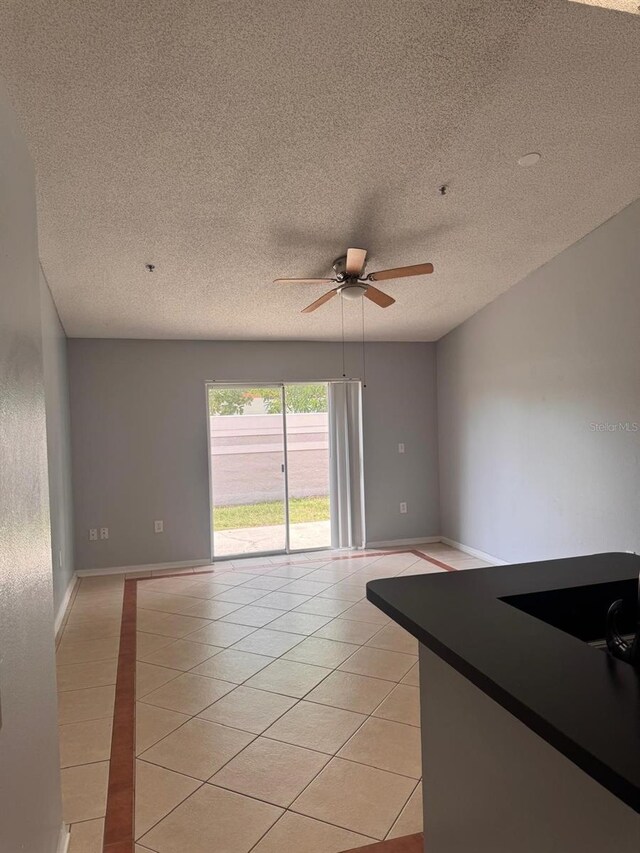 1603 Emily Ct, Kissimmee, FL 34744 - unfurnished room featuring light tile patterned floors, a ceiling fan, and a textured ceiling