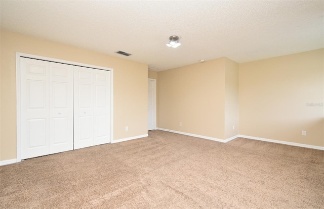 115 Bristol Forest Trl, Sanford, FL 32771 - unfurnished bedroom featuring carpet flooring, baseboards, a closet, and a textured ceiling
