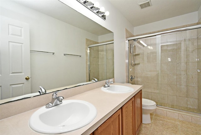 115 Bristol Forest Trl, Sanford, FL 32771 - bathroom with a shower stall, tile patterned flooring, double vanity, and toilet