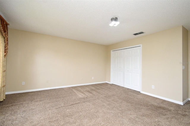 115 Bristol Forest Trl, Sanford, FL 32771 - unfurnished bedroom with carpet flooring, baseboards, a closet, and a textured ceiling