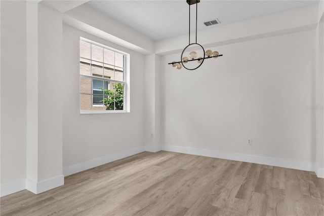 12917 Grovehurst Ave, Winter Garden, FL 34787 - unfurnished room with a chandelier, wood finished floors, and baseboards