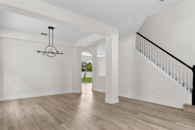 12917 Grovehurst Ave, Winter Garden, FL 34787 - unfurnished dining area featuring wood finished floors, stairway, arched walkways, and baseboards