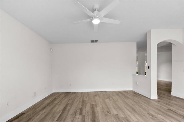 12917 Grovehurst Ave, Winter Garden, FL 34787 - spare room featuring wood finished floors, arched walkways, ceiling fan, and baseboards