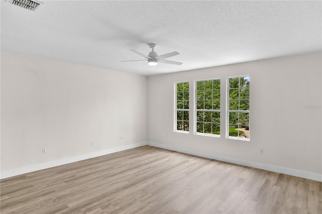 12917 Grovehurst Ave, Winter Garden, FL 34787 - empty room with light wood-style flooring, a textured ceiling, baseboards, and a ceiling fan