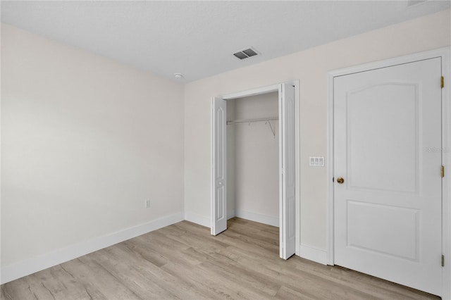 12917 Grovehurst Ave, Winter Garden, FL 34787 - unfurnished bedroom featuring light wood-type flooring, baseboards, and a closet