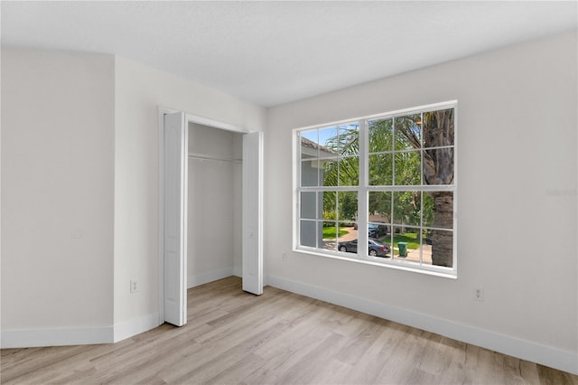 12917 Grovehurst Ave, Winter Garden, FL 34787 - unfurnished bedroom featuring light wood-type flooring, baseboards, and a closet