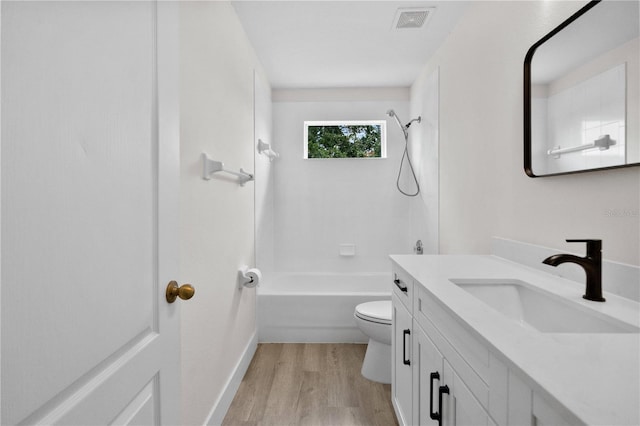 12917 Grovehurst Ave, Winter Garden, FL 34787 - bathroom featuring wood finished floors, toilet, vanity, tub / shower combination, and baseboards