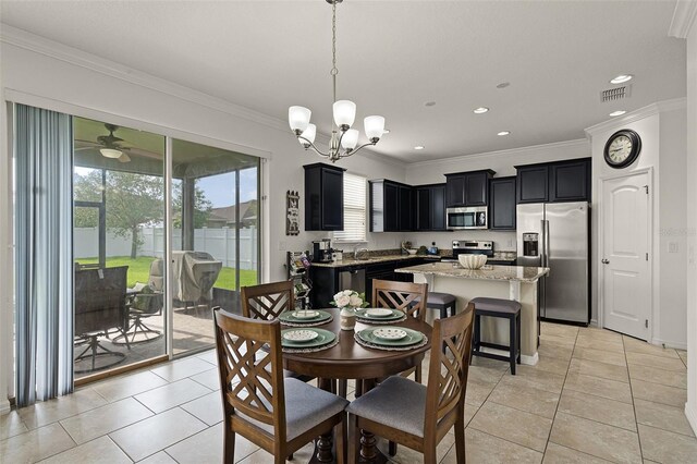 1553 Caterpillar St, Saint Cloud, FL 34771 - dining area with light tile patterned floors, ornamental molding, recessed lighting, and a chandelier