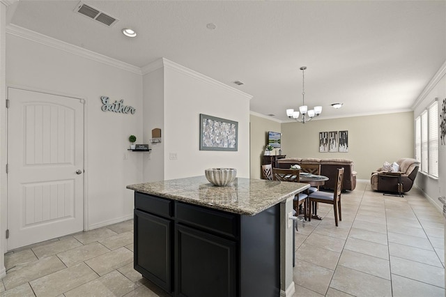 1553 Caterpillar St, Saint Cloud, FL 34771 - kitchen with a chandelier, dark cabinets, ornamental molding, light tile patterned floors, and a center island