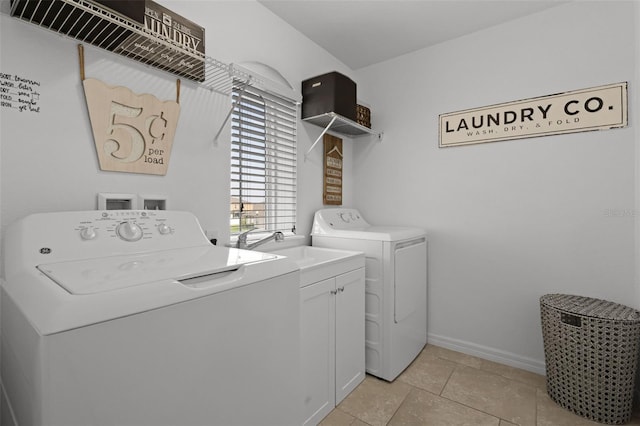 1553 Caterpillar St, Saint Cloud, FL 34771 - laundry area featuring washing machine and clothes dryer, cabinet space, baseboards, and light tile patterned floors
