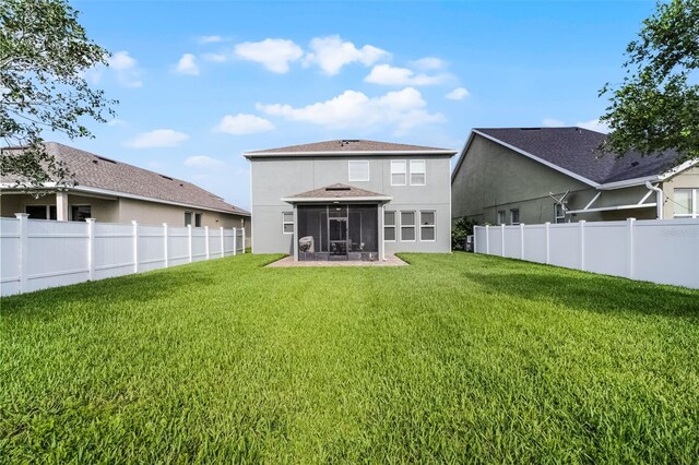 1553 Caterpillar St, Saint Cloud, FL 34771 - rear view of house featuring a sunroom, stucco siding, and roof with shingles