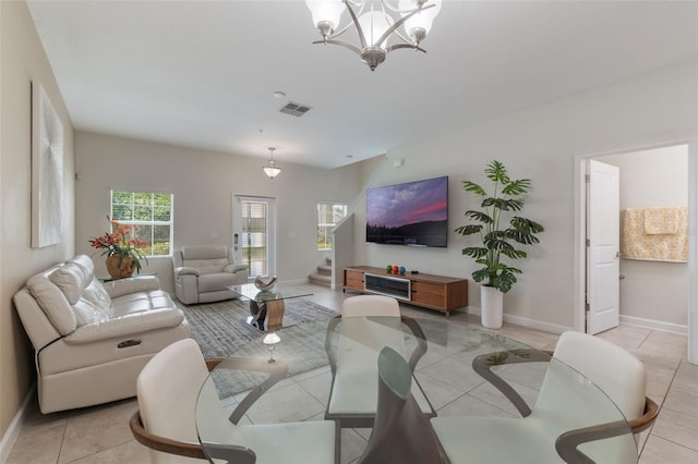 11631 Mystery Ln, Orlando, FL 32832 - living room featuring stairway, a chandelier, baseboards, and light tile patterned floors