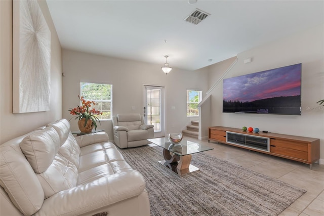 11631 Mystery Ln, Orlando, FL 32832 - living area with light tile patterned flooring, stairway, and healthy amount of natural light