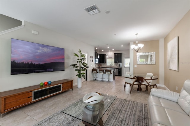 11631 Mystery Ln, Orlando, FL 32832 - living area with light tile patterned floors, a chandelier, and baseboards