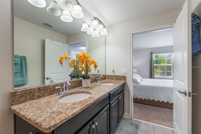 11631 Mystery Ln, Orlando, FL 32832 - ensuite bathroom featuring a chandelier, tile patterned flooring, double vanity, and a textured ceiling