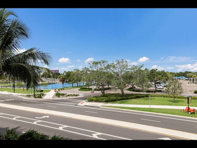 1064 N Tamiami Trl Unit 1219, Sarasota, FL 34236 - view of asphalt street featuring traffic signs, curbs, sidewalks, and a water view