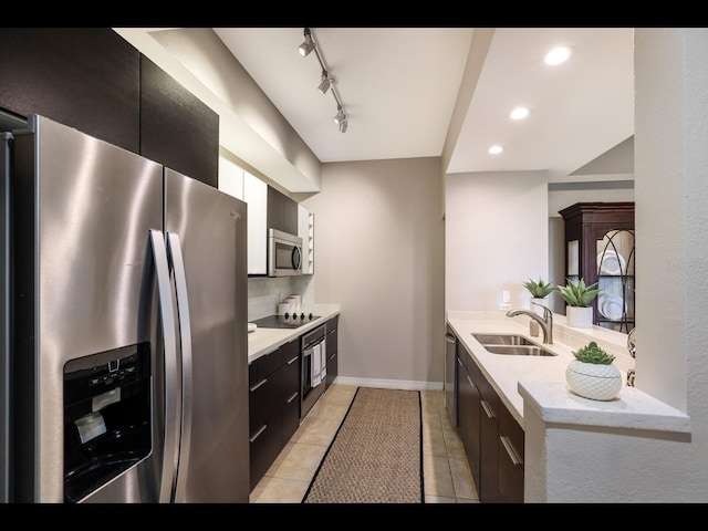 1064 N Tamiami Trl Unit 1219, Sarasota, FL 34236 - kitchen with stainless steel appliances, a sink, modern cabinets, dark cabinetry, and backsplash