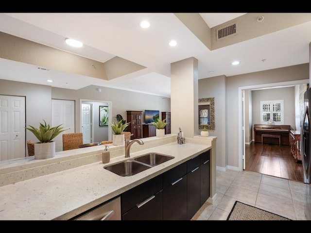 1064 N Tamiami Trl Unit 1219, Sarasota, FL 34236 - kitchen with a sink, open floor plan, light tile patterned floors, baseboards, and dark cabinets