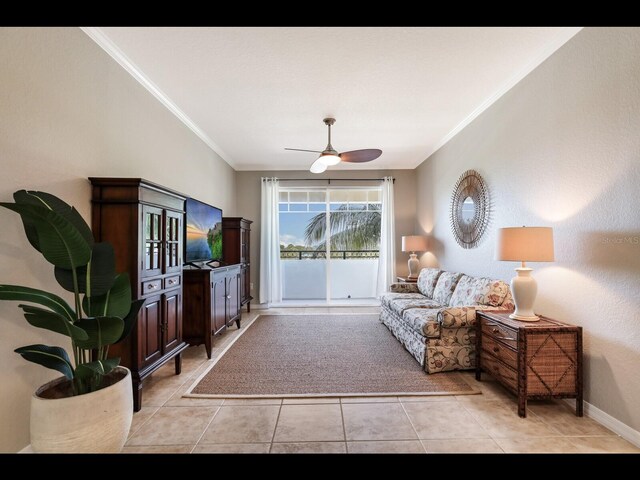 1064 N Tamiami Trl Unit 1219, Sarasota, FL 34236 - living room with crown molding, light tile patterned floors, a ceiling fan, and baseboards