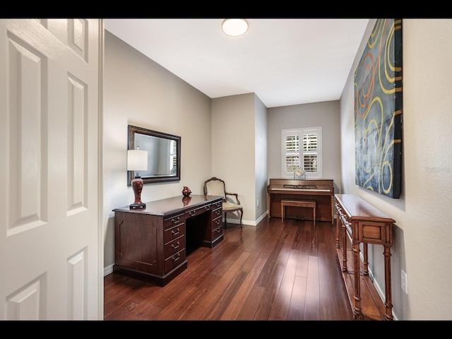 1064 N Tamiami Trl Unit 1219, Sarasota, FL 34236 - hallway featuring dark wood-type flooring, baseboards, and a desk