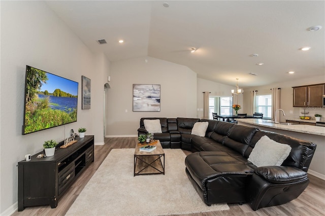 871 Orleans Dr, Eagle Lake, FL 33839 - living room with light wood-type flooring, lofted ceiling, a chandelier, baseboards, and recessed lighting