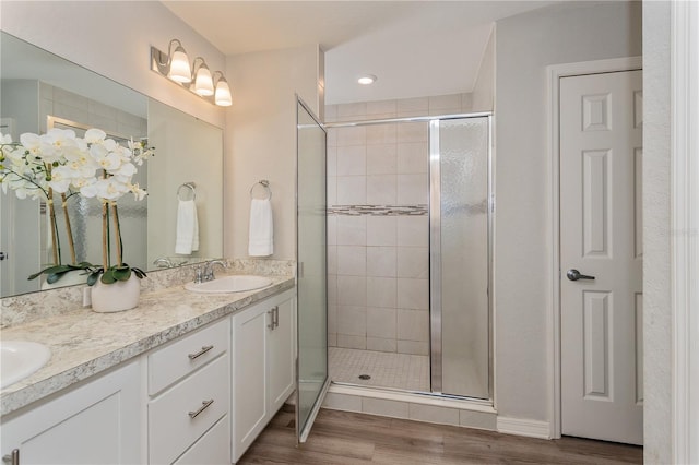 871 Orleans Dr, Eagle Lake, FL 33839 - full bath with a shower stall, wood finished floors, and double vanity