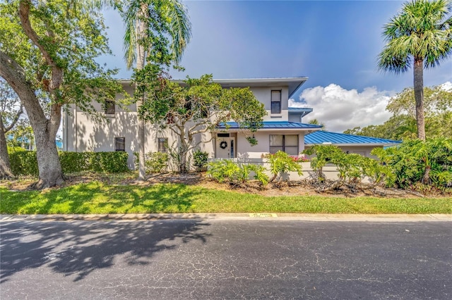 1672 Watermark Cir NE, Saint Petersburg, FL 33702 - view of front of home with a standing seam roof, stucco siding, and metal roof
