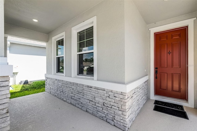 10249 Spring Lake Dr, Clermont, FL 34711 - doorway to property featuring stucco siding and a porch