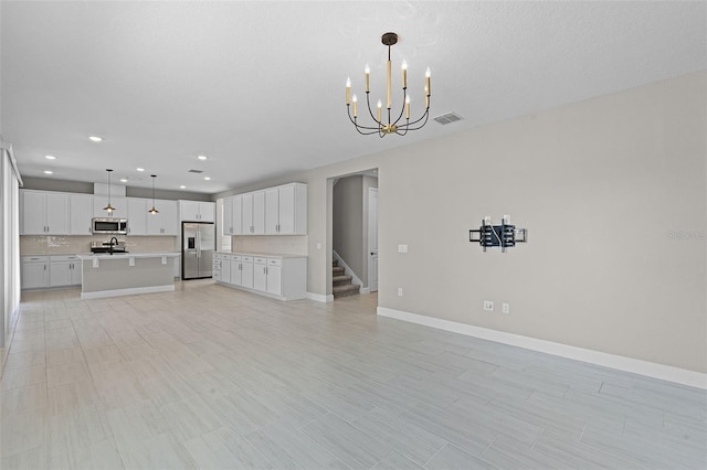 10249 Spring Lake Dr, Clermont, FL 34711 - unfurnished living room featuring a chandelier, recessed lighting, and stairway