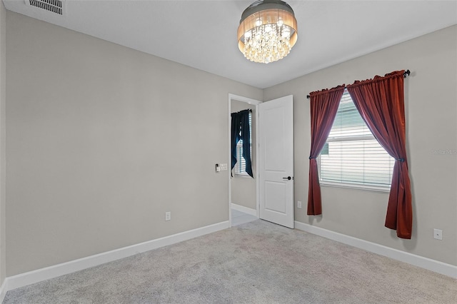 10249 Spring Lake Dr, Clermont, FL 34711 - empty room featuring a chandelier and carpet flooring