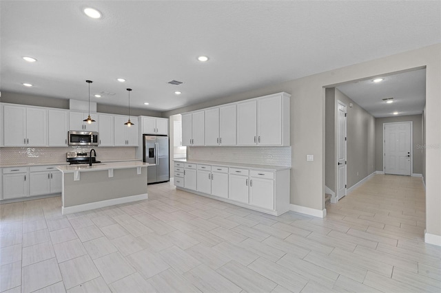 10249 Spring Lake Dr, Clermont, FL 34711 - kitchen with appliances with stainless steel finishes, tasteful backsplash, light countertops, white cabinetry, and recessed lighting